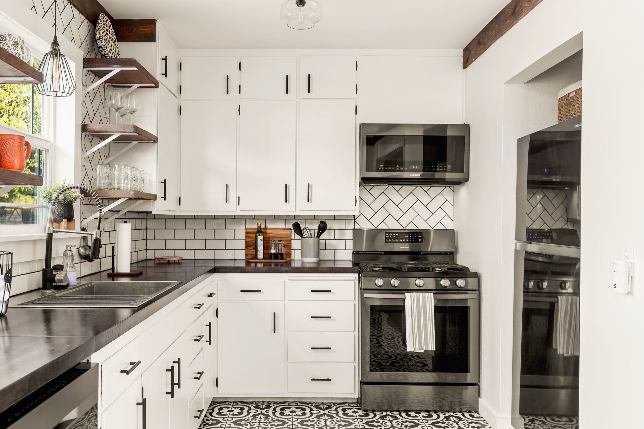 Kitchen with white cabinets and subway tile