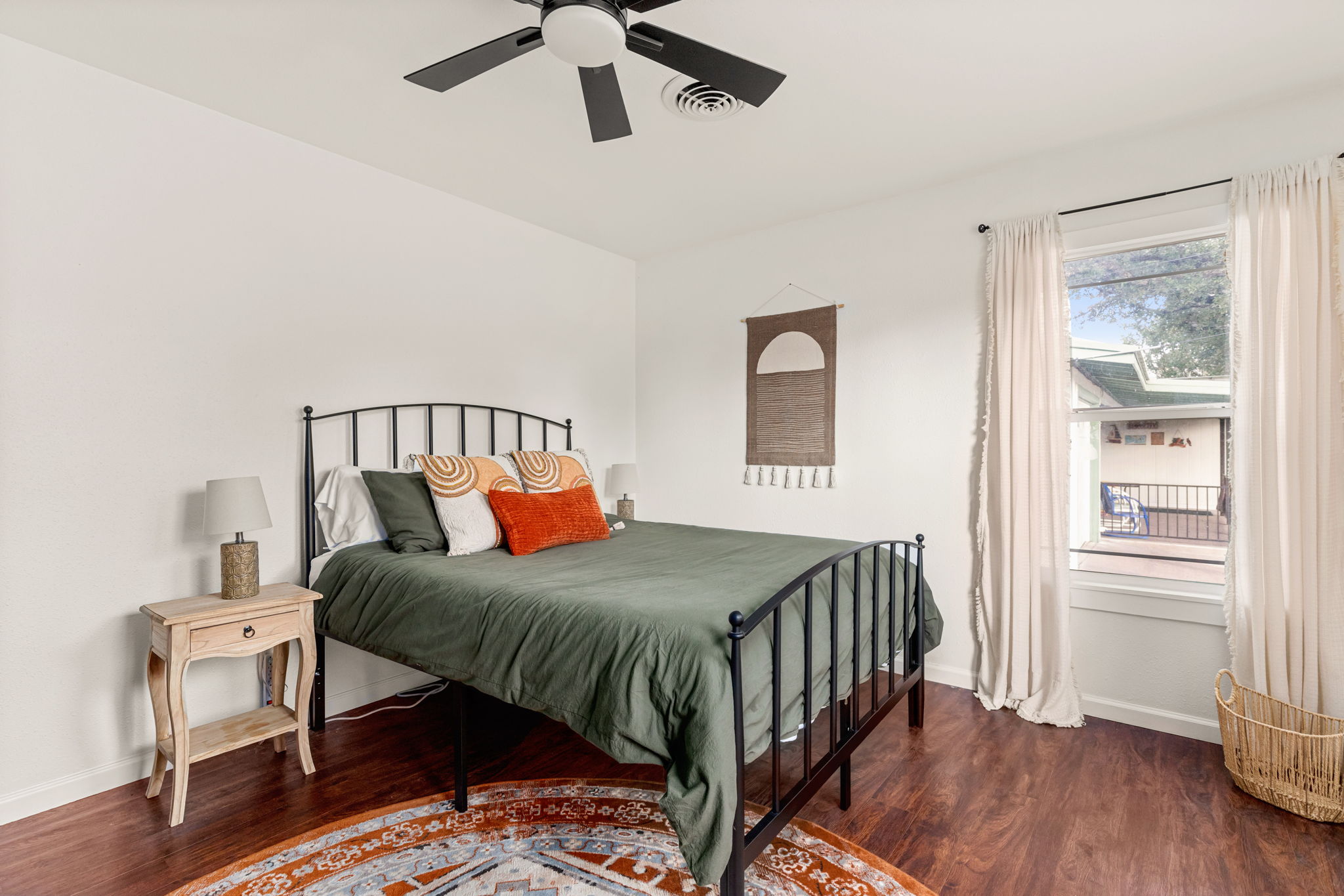 Second bedroom full view with boho rug