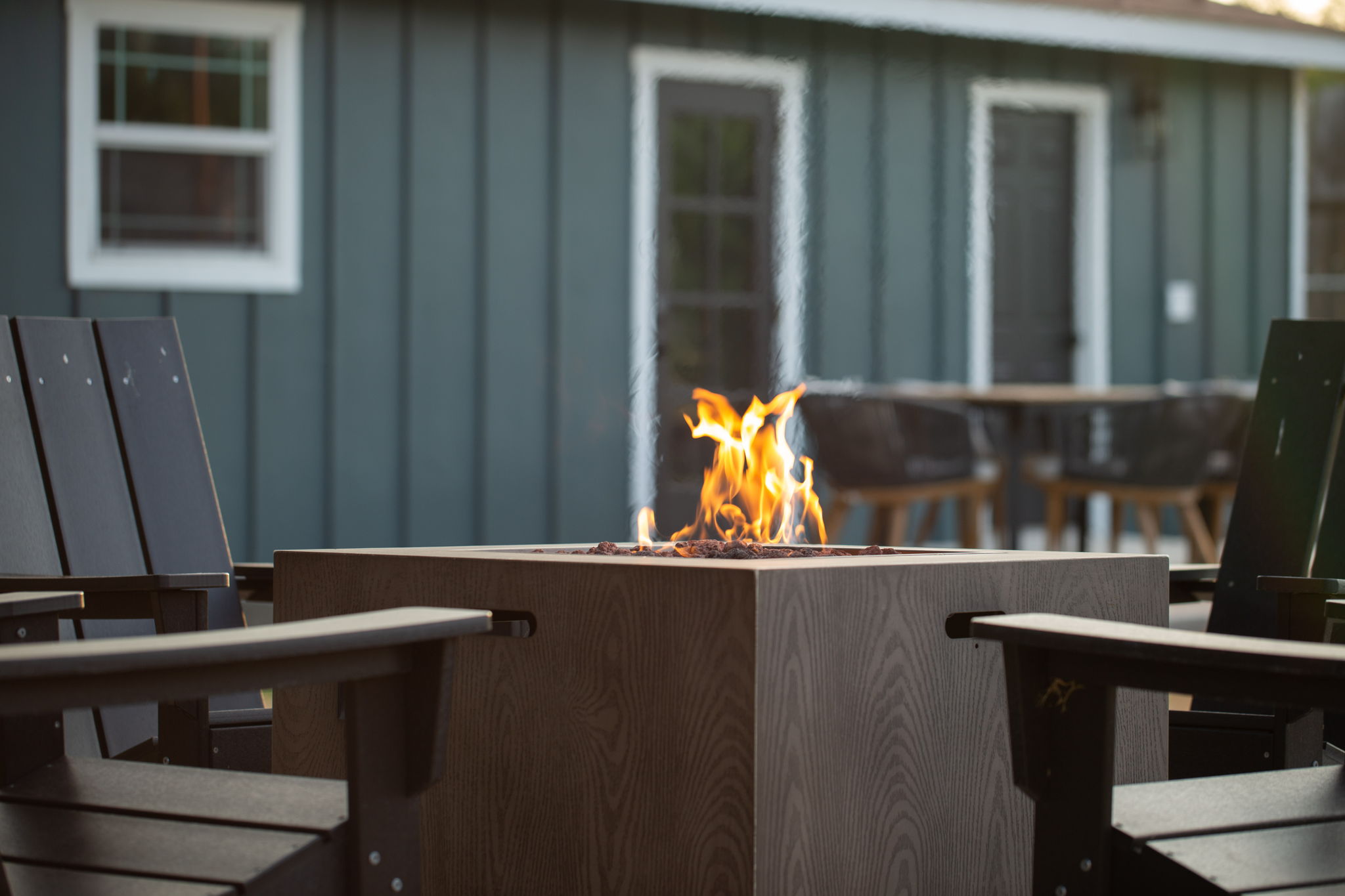 Fire pit with Adirondack chairs at dusk