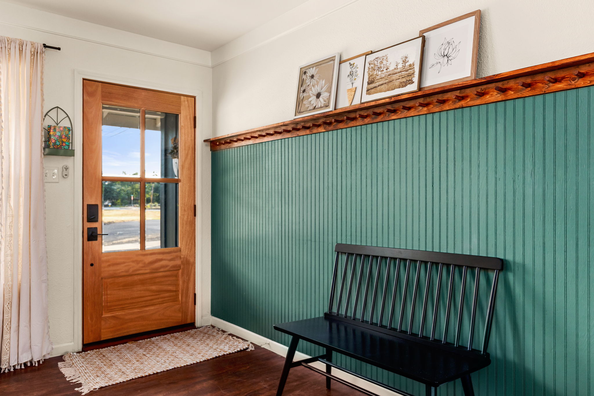 Entry with teal beadboard and bench