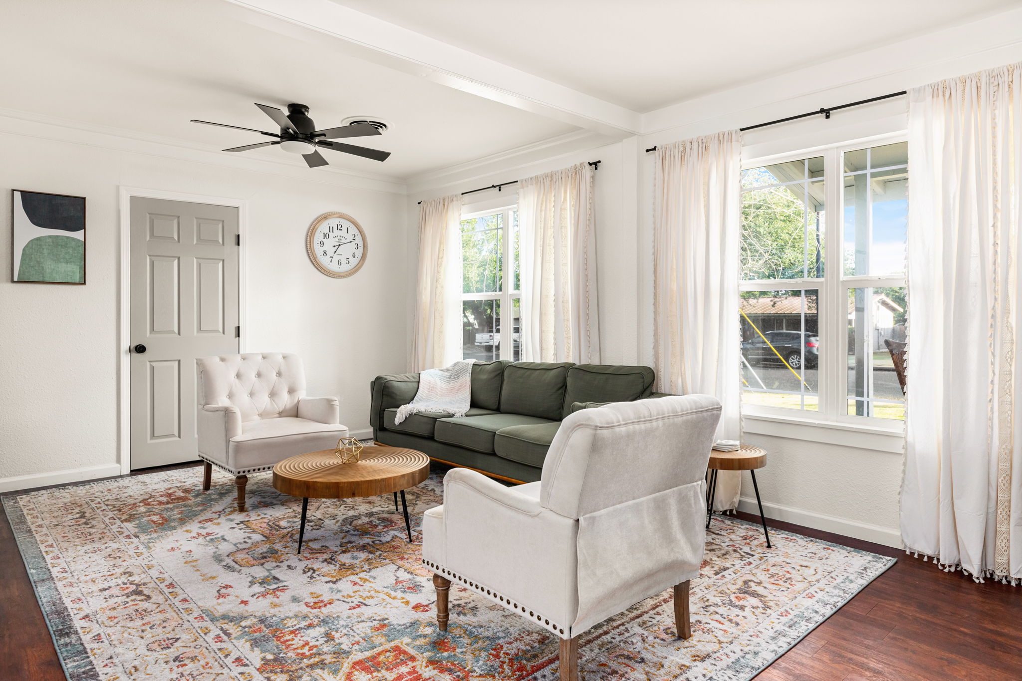 Mulberry House living room with green sofa and boho rug