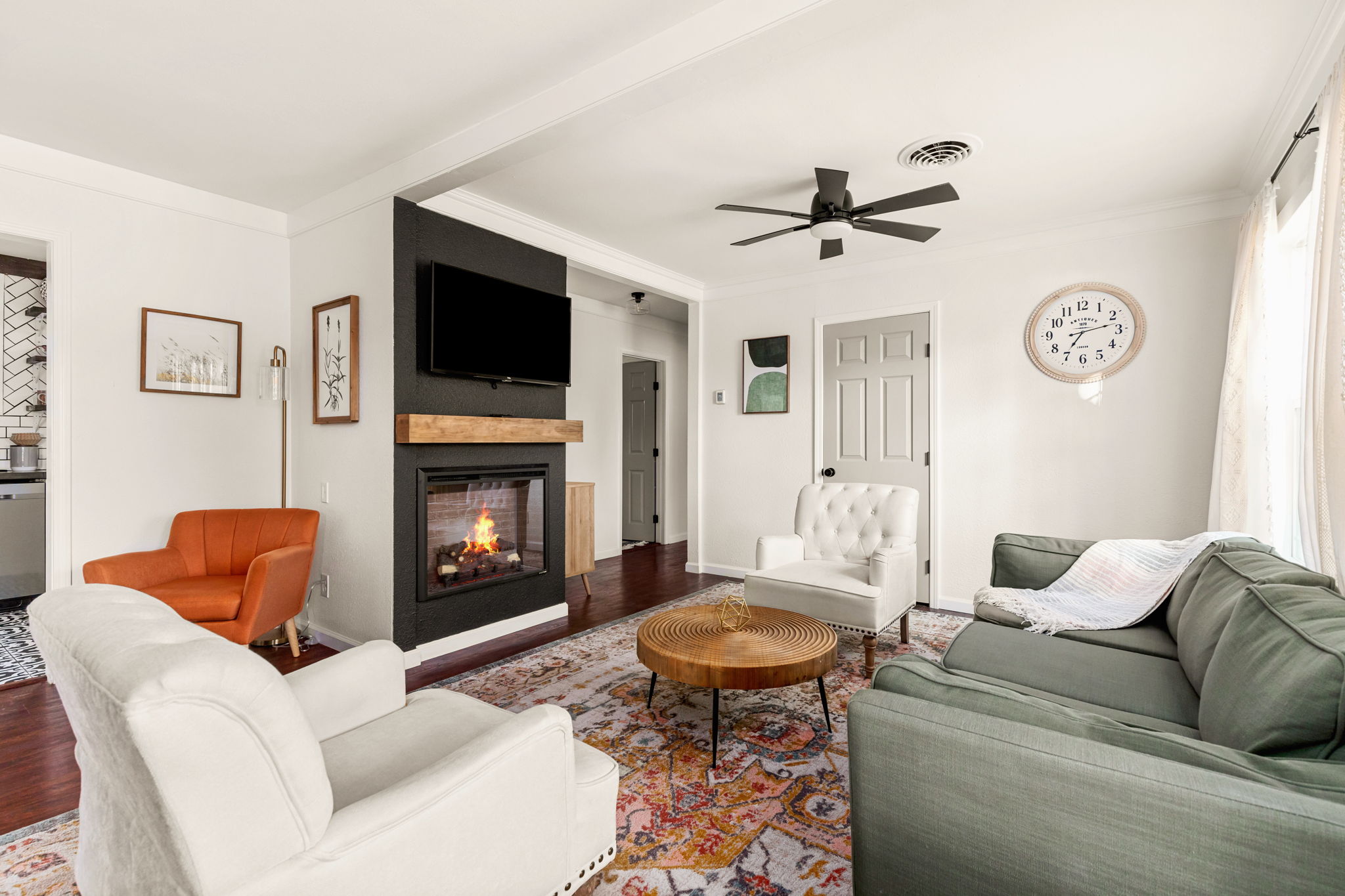 Living room with fireplace and orange velvet chair