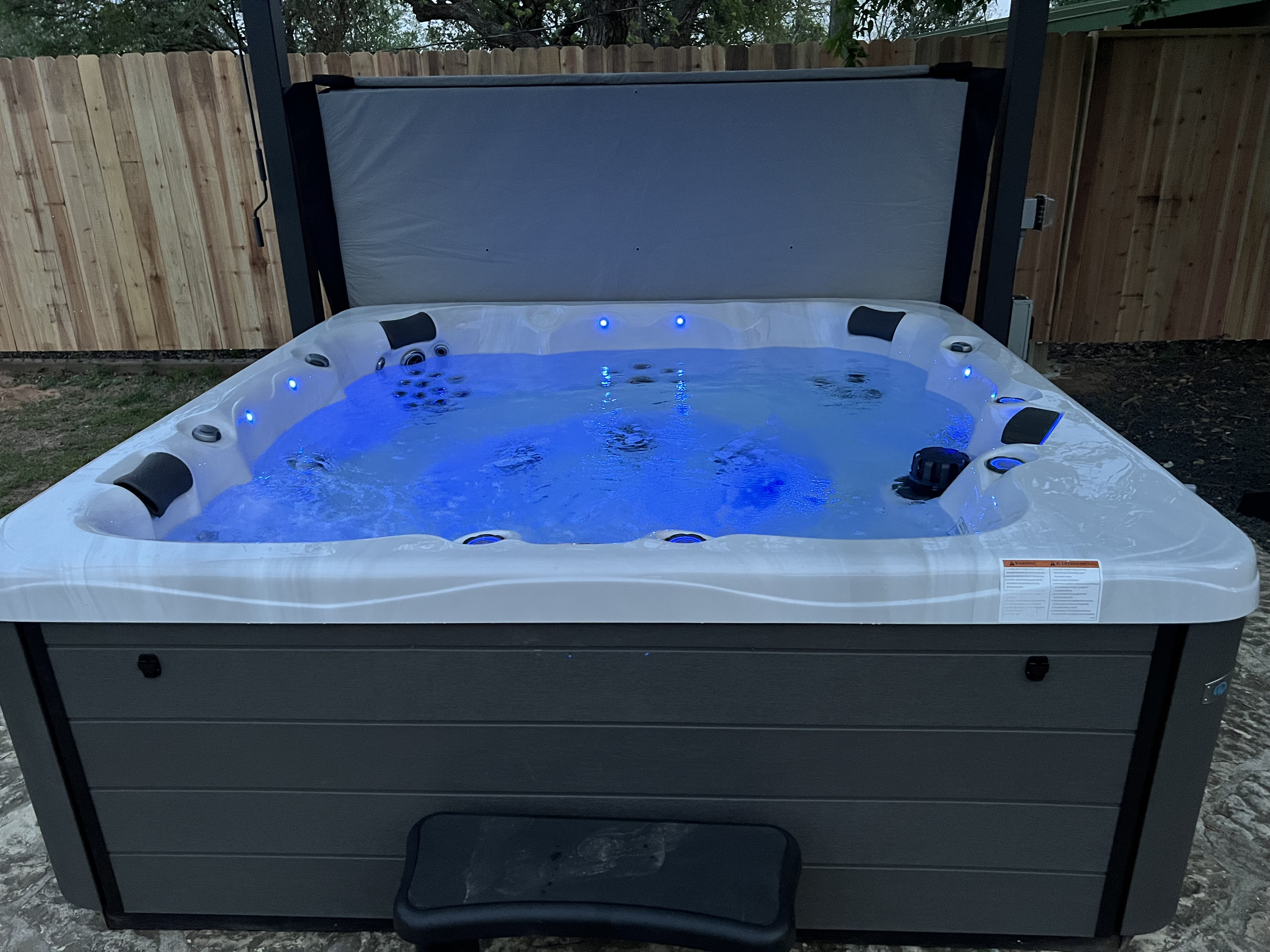 Private hot tub glowing blue at night